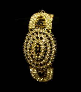 Gold-Plated Oval Bangles with concentric crystal patterns in black, aqua, and ruby tones from L’Africaine Boutique.