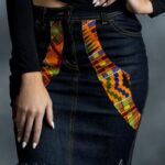 Heritage Denim Skirt in dark-wash denim with diagonal Kente-inspired Ankara panels and raw hem from L’Africaine Boutique.