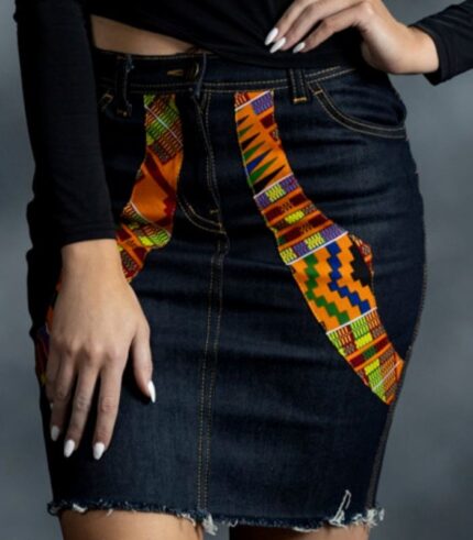 Heritage Denim Skirt in dark-wash denim with diagonal Kente-inspired Ankara panels and raw hem from L’Africaine Boutique.