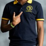 Midnight Gold Polo shirt in deep navy with golden-yellow collar and sleeve tips, featuring embroidered L’Africaine Boutique logo.