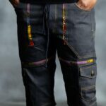 Multi-Accent Jorts in deep blue denim with golden triangular patches, designed by L’Africaine Boutique.