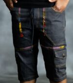 Multi-Accent Jorts in deep blue denim with golden triangular patches, designed by L’Africaine Boutique.