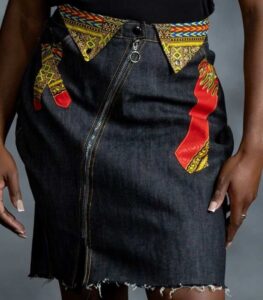 Pop Zipper Skirt in black denim with full-length zipper, frayed hem, and white Ankara accents with teal, yellow, orange, and black from L’Africaine Boutique.
