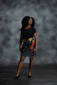 Pop Zipper Skirt in black denim with full-length zipper, frayed hem, and white Ankara accents with teal, yellow, orange, and black from L’Africaine Boutique.
