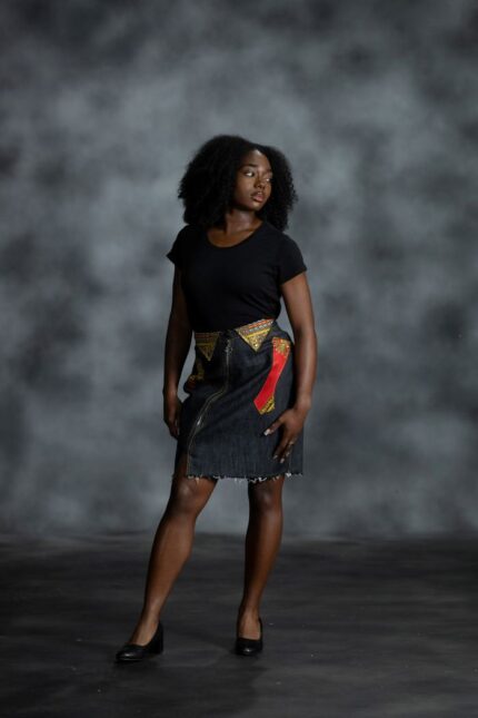 Pop Zipper Skirt in black denim with full-length zipper, frayed hem, and white Ankara accents with teal, yellow, orange, and black from L’Africaine Boutique.