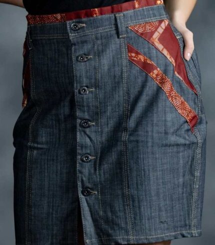 Red Accent Skirt in medium-wash denim with burgundy Ankara waistband and side inserts from L’Africaine Boutique.