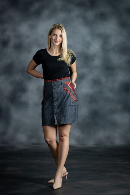 Red Accent Skirt in medium-wash denim with burgundy Ankara waistband and side inserts from L’Africaine Boutique.