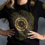 Radiance Burst Tee with circular African print in green and gold, symbolizing light and resilience—L’Africaine Boutique.