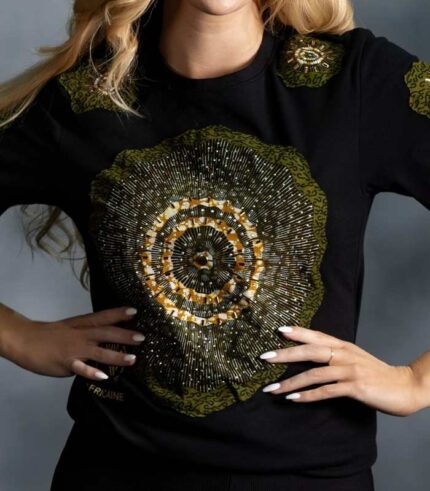 Radiance Burst Tee with circular African print in green and gold, symbolizing light and resilience—L’Africaine Boutique.