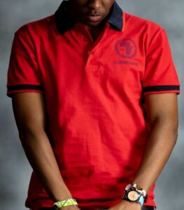 Red Power Polo shirt with navy collar and sleeve accents, featuring embroidered L’Africaine Boutique logo on the chest.