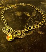 Gold-plated Regal Gemstone Cascade Necklace with emerald, sapphire, and ruby stones in openwork links from L’Africaine Boutique.