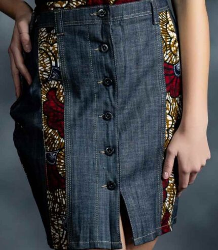 Tribal Curve Skirt in dark indigo denim with curved orange, green, yellow, and blue Ankara panels from L’Africaine Boutique.