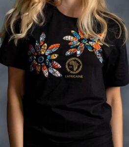 Twin Flower Tee with two African floral prints, rhinestone centers, and gold logo on black cotton from L’Africaine Boutique.