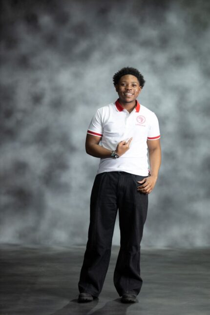 White Fire Polo shirt with red collar and sleeve accents, featuring embroidered L’Africaine Boutique logo on the chest.