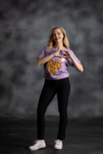 You Are Loved Lilac Tee with yellow African print heart, scattered stars, and red lips from L’Africaine Boutique.