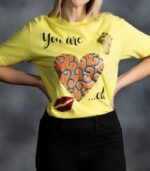 You Are Loved Tee with African print heart, raised fist, and glitter lips from L’Africaine Boutique.