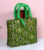 ankara emerald wave handbag in green and gold Ankara wax fabric with wave-like and teardrop motifs, padded handles, and structured boxy silhouette.