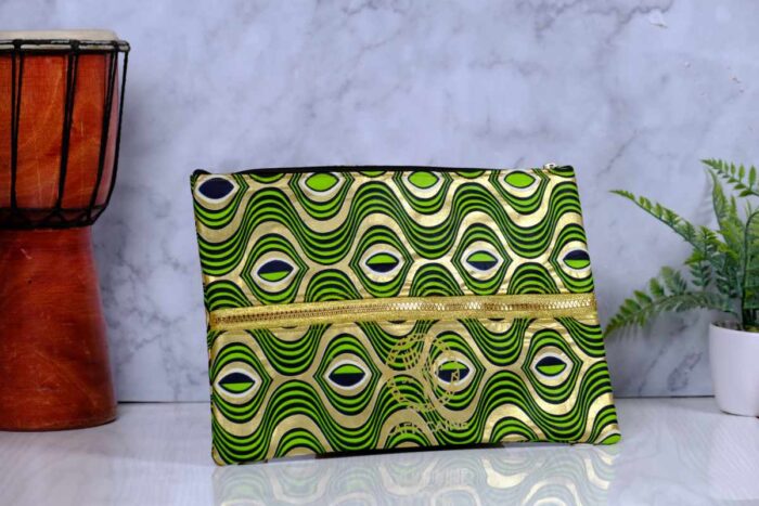 ankara gold wave clutch by L’Africaine Boutique—crafted from wax fabric with gold and green wave print, black detailing, and gold zipper for day or night.