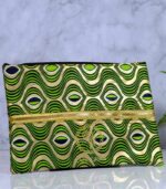 ankara gold wave clutch by L’Africaine Boutique—crafted from wax fabric with gold and green wave print, black detailing, and gold zipper for day or night.