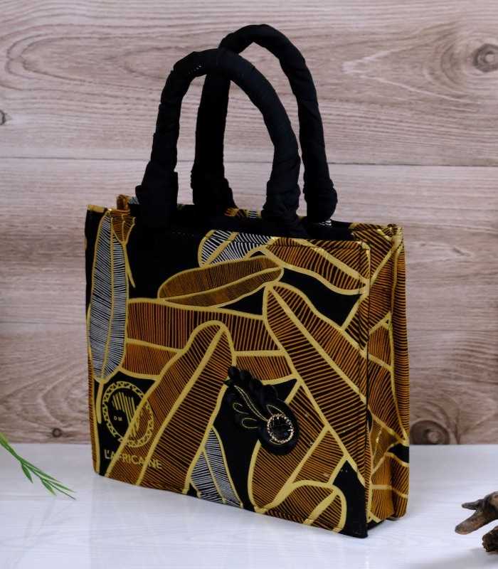 Ankara golden noir handbag 3 ankara golden noir handbag in black and golden-brown Ankara wax fabric with feather-like motifs, padded black handles, structured silhouette, and handcrafted front accent.