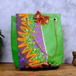 ankara green sequin tote by L’Africaine Boutique—crafted from wax fabric with green faux leather, gold chain strap, and sequin bow for luxury style.
