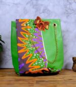 ankara green sequin tote by L’Africaine Boutique—crafted from wax fabric with green faux leather, gold chain strap, and sequin bow for luxury style.