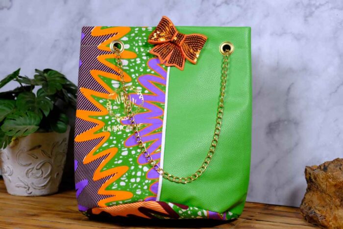 ankara green sequin tote by L’Africaine Boutique—crafted from wax fabric with green faux leather, gold chain strap, and sequin bow for luxury style.