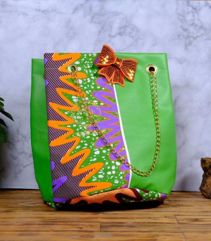 Ankara green sequin tote ankara green sequin tote by L’Africaine Boutique—crafted from wax fabric with green faux leather, gold chain strap, and sequin bow for luxury style.