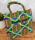 ankara kente motif tote in multicolor Ankara wax fabric with Kente-inspired geometric patterns, curved cut-out top, padded handles, and front zipper pocket.